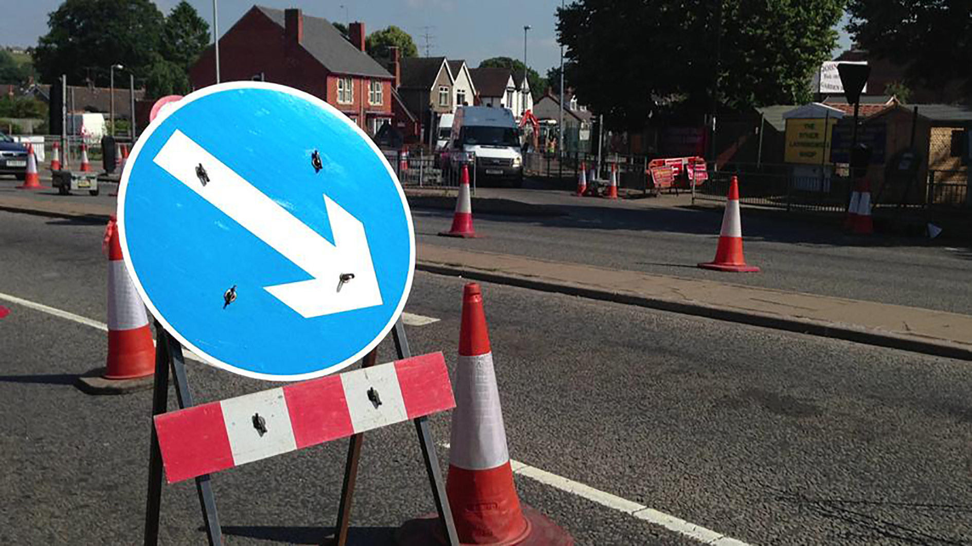 Signs and cones on a road.