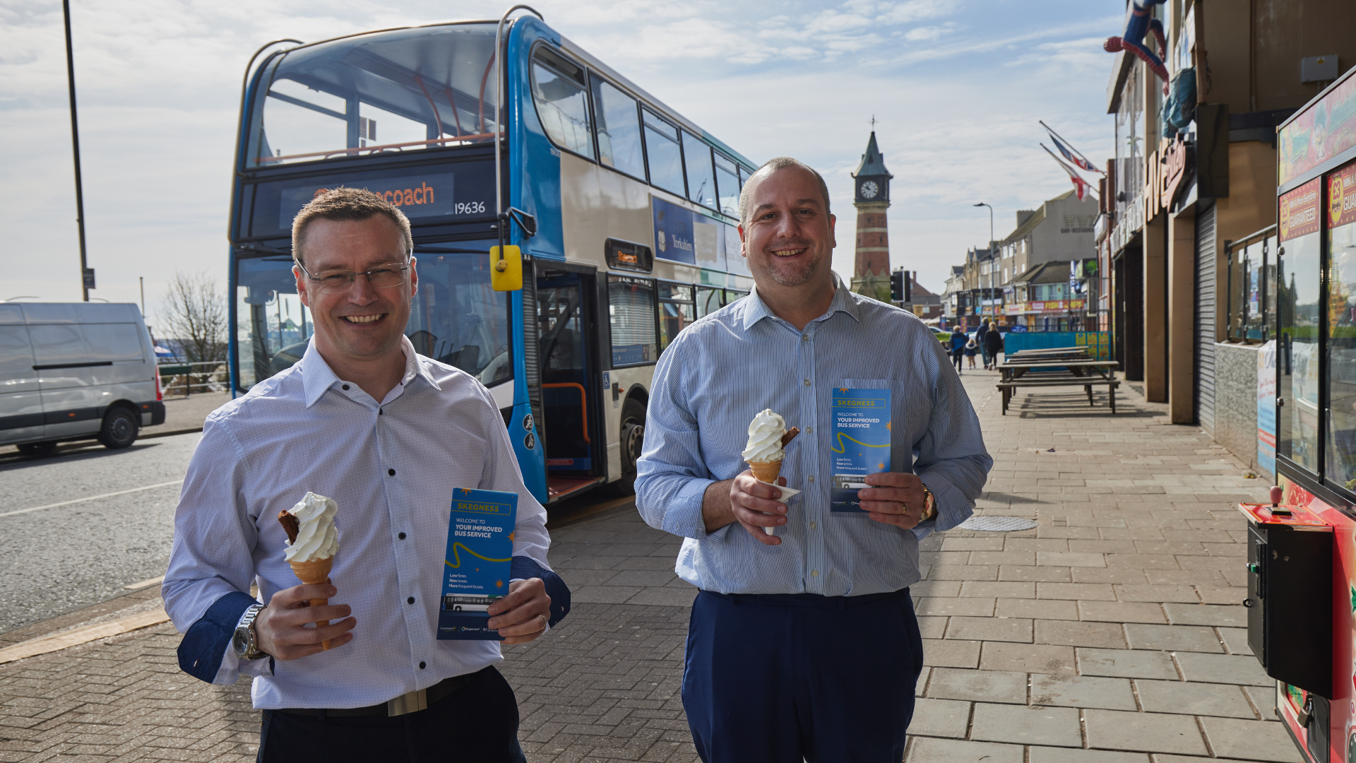 Cllr Carl Macey and Cllr Richard Davies stood in front of a bus holding icecreams