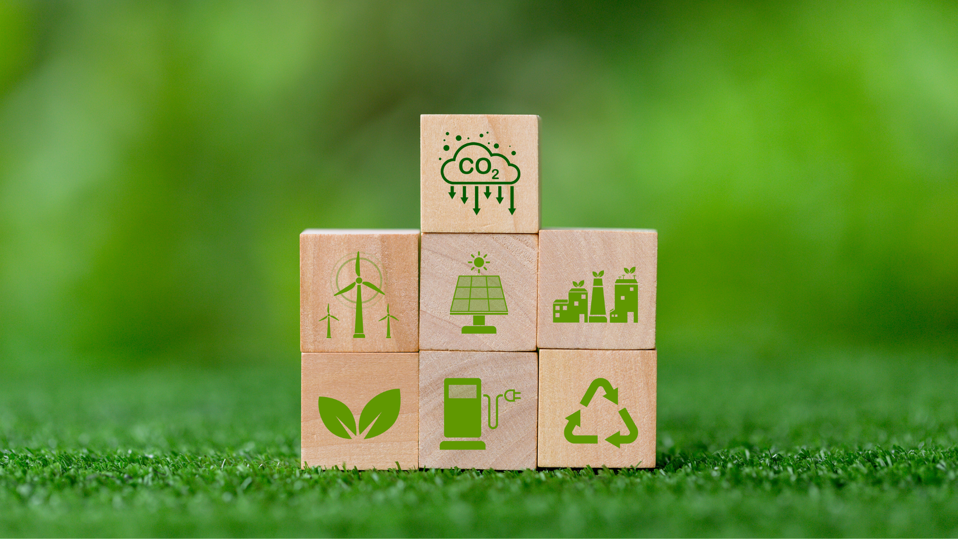 A set of wooden dice with symbols representing carbon emissions