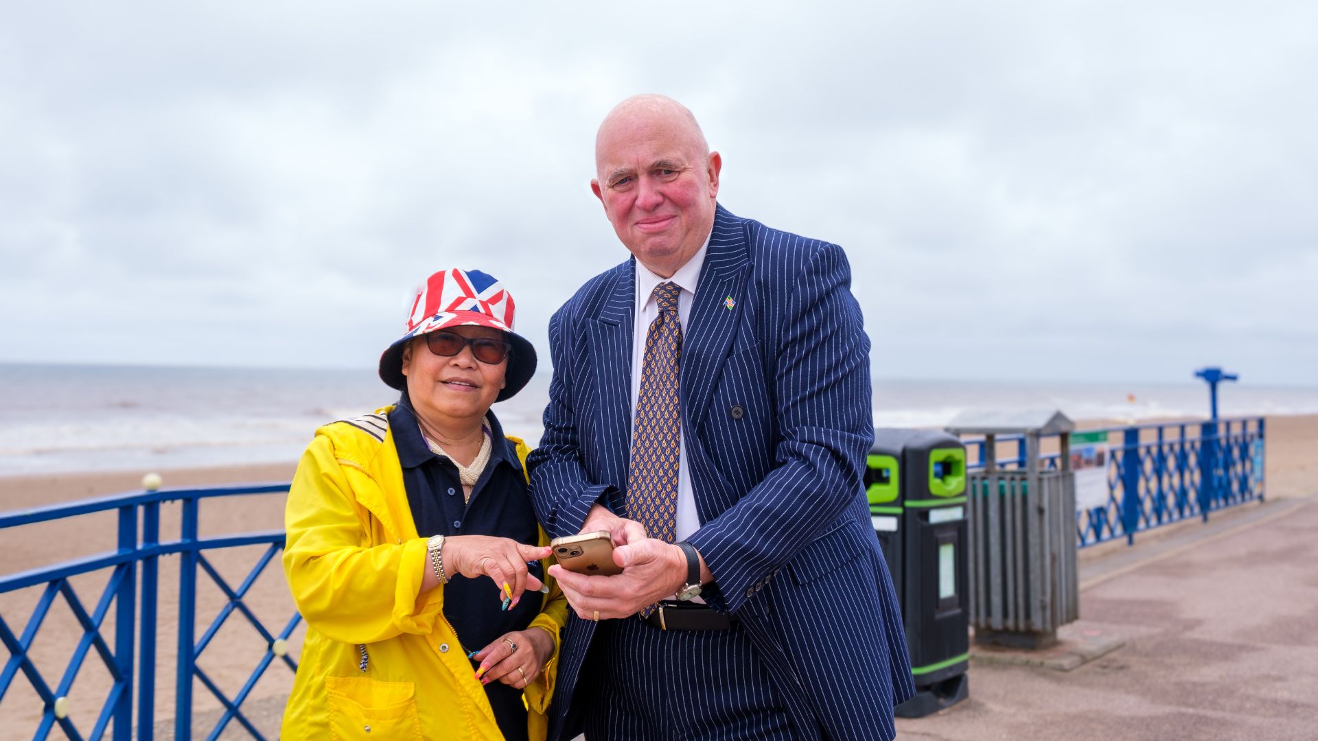 Cllr Colin Davies uses a phone to look at the Mablethorpe app