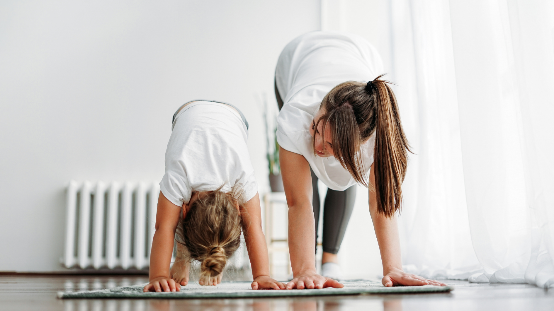 A mother and daughter do yoga together