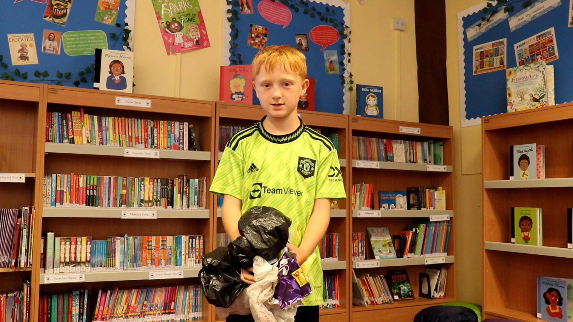 A pupil at Leslie Manser Primary School holds a stack of soft plastics