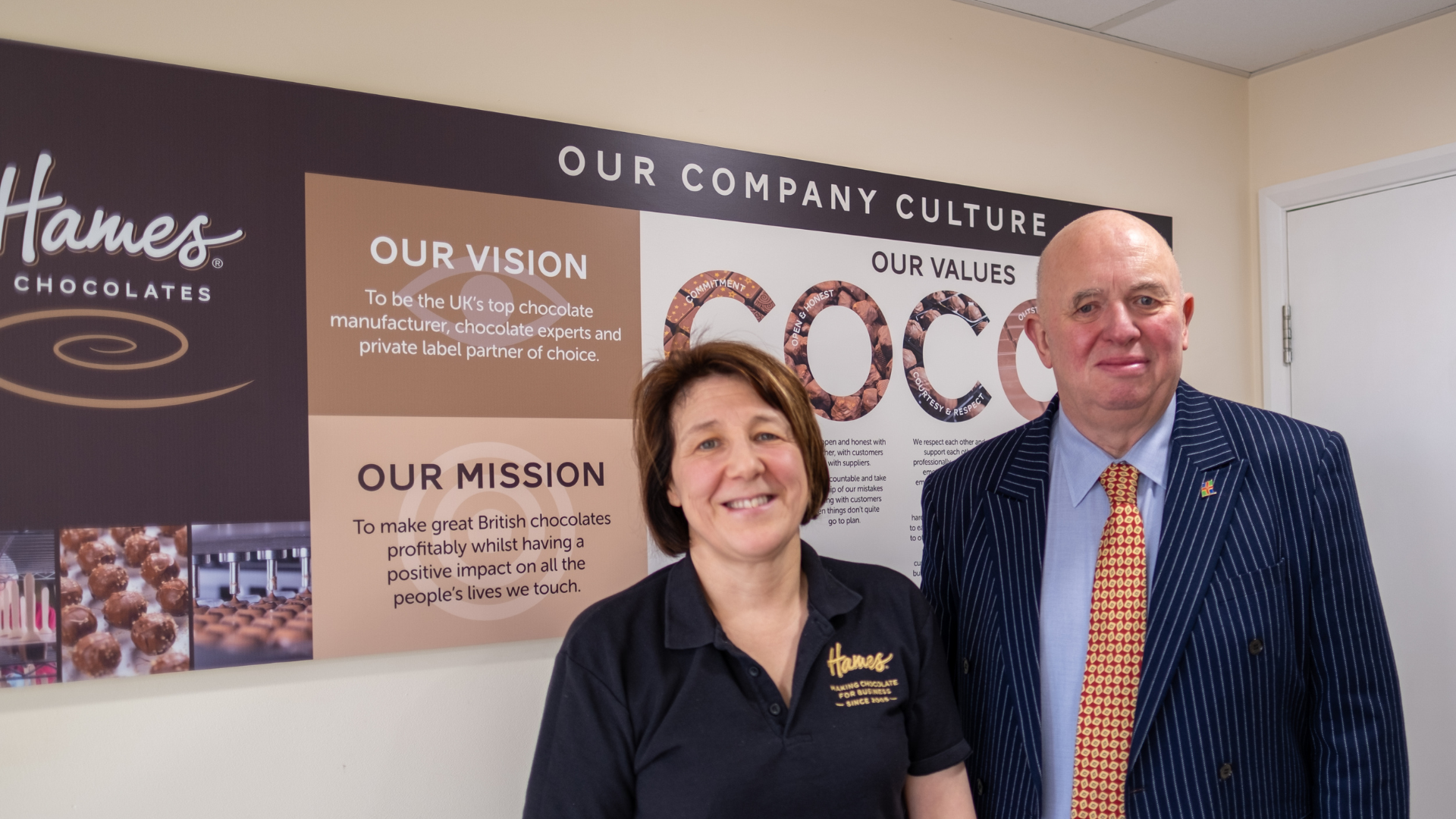 Picture of Carol Oldbury and Councillor Colin Davie in front of an information board about chocolate