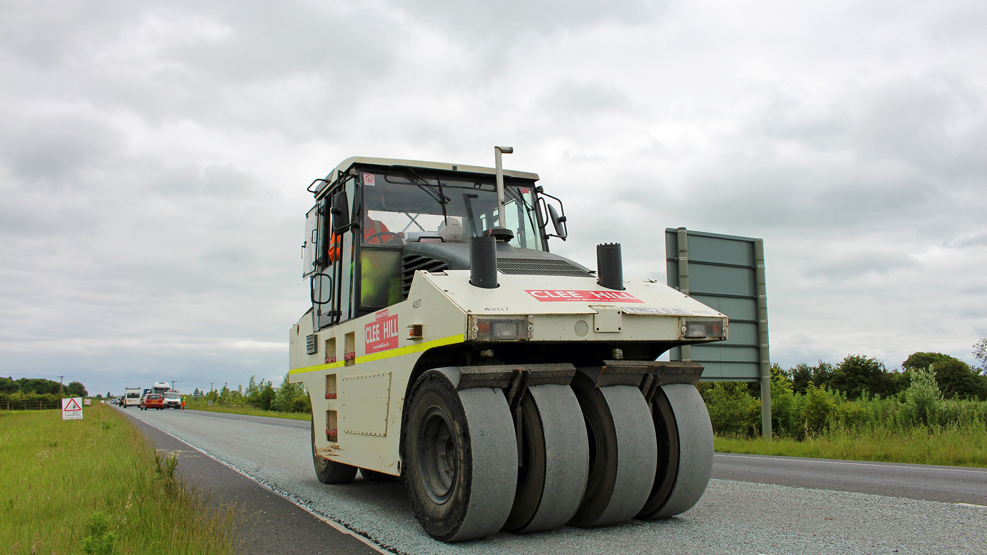 Highway maintenance machine roller working on resurfacing the road