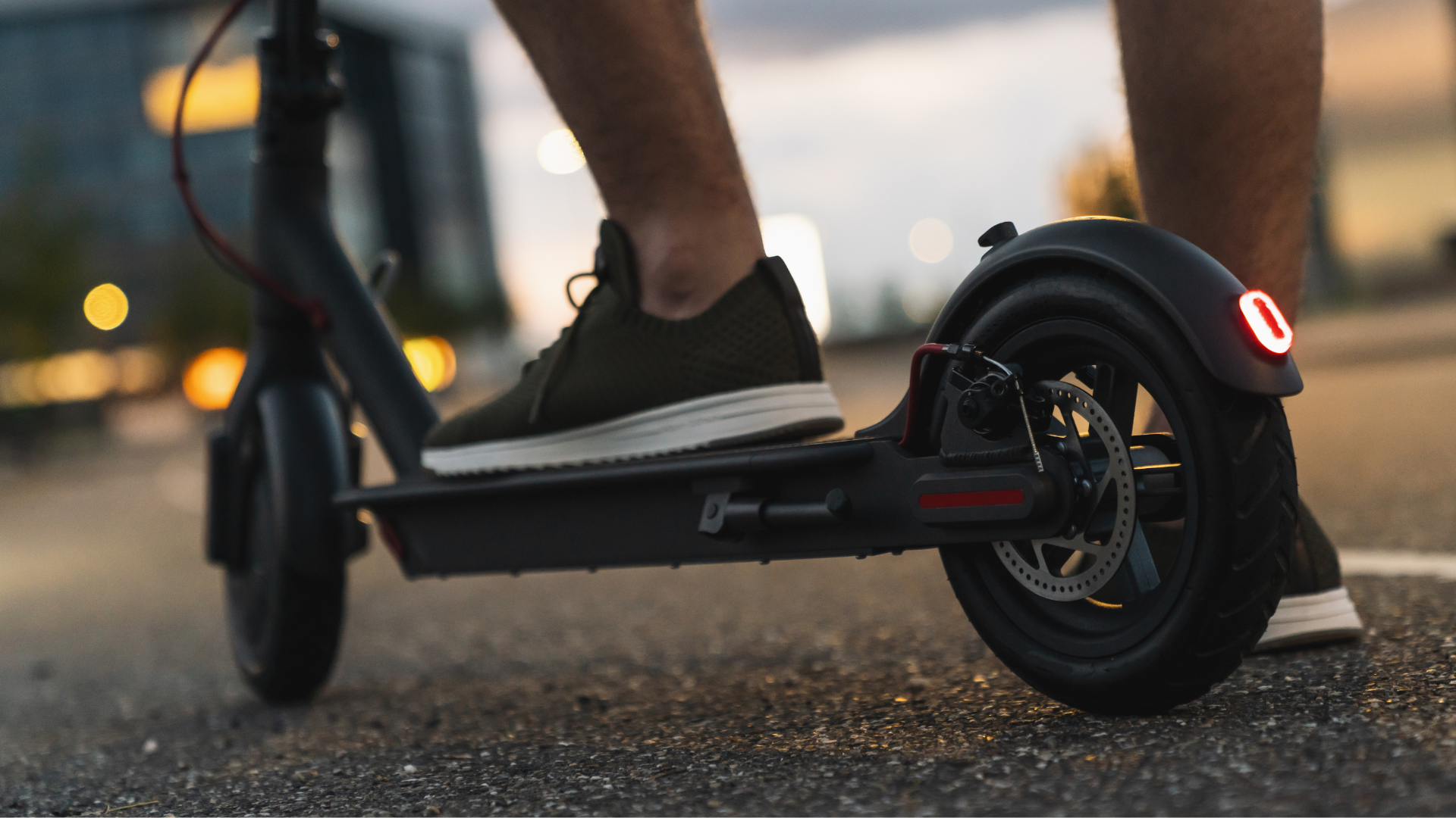 A person stood on an e-scooter