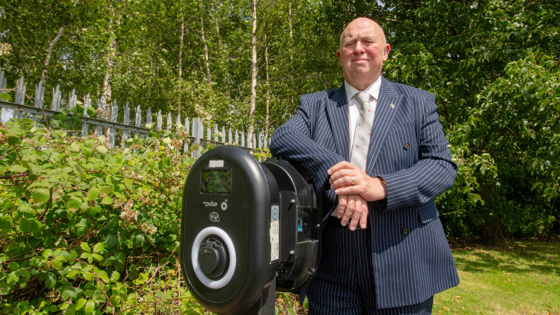 Cllr Davie stood near an EV charger