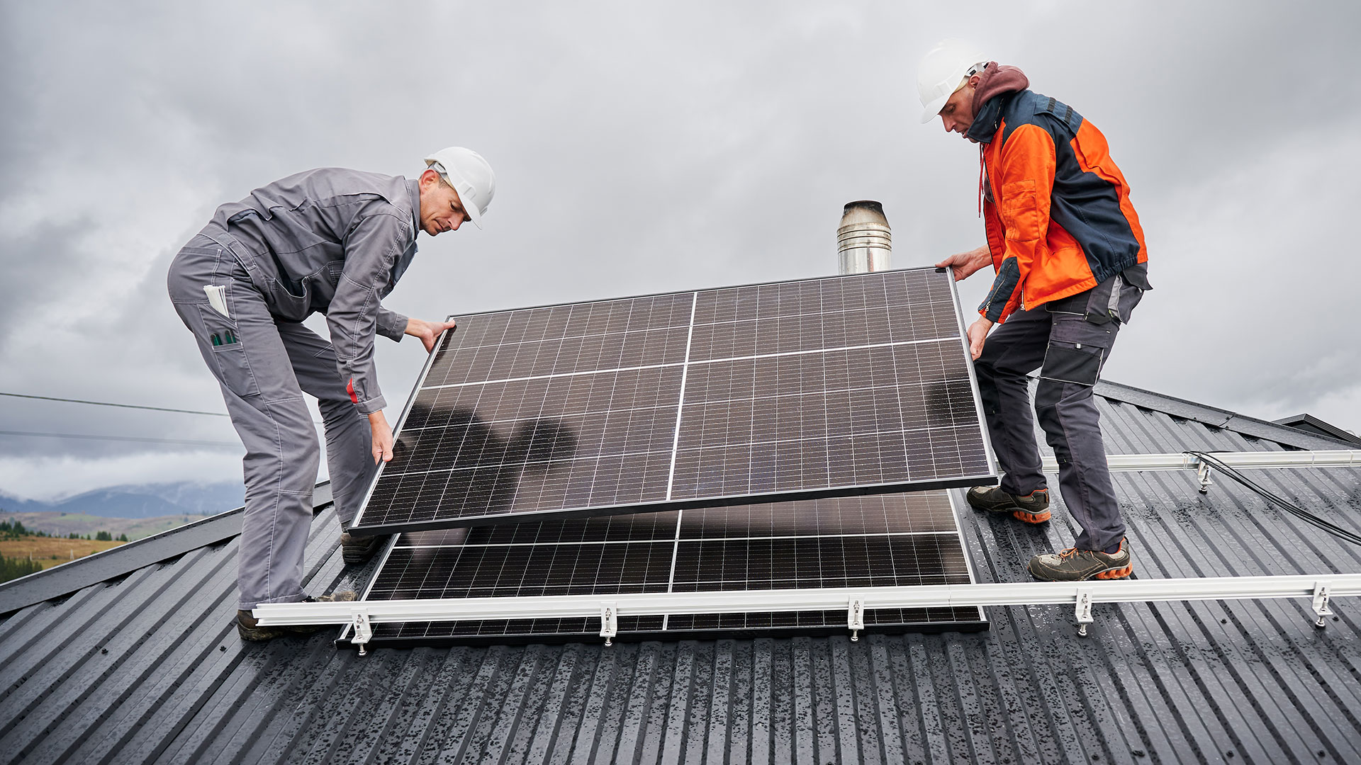 Technicians installing a solar module